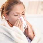 Young Woman Having Flu Blowing Her Nose