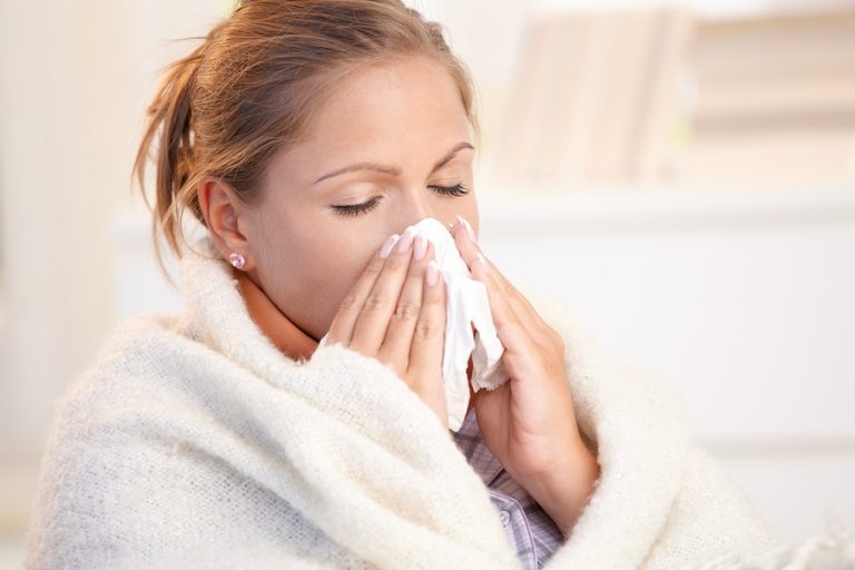 Young Woman Having Flu Blowing Her Nose